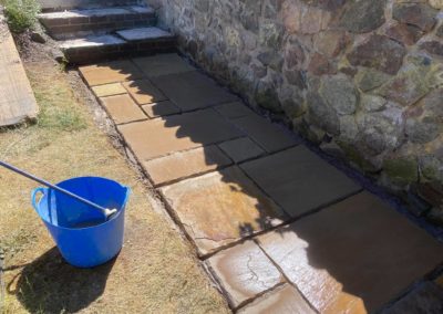 Stone wall and freshly tiled pathway