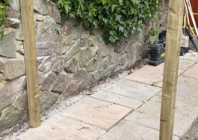 Tiled pathway and wooden posts for gate