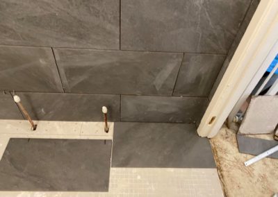 Laying bathroom tiles around pipe work