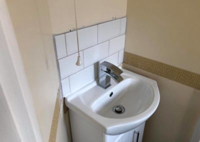 New corner sink with white tiling