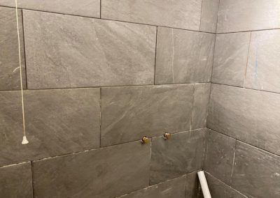 Fitting bathroom tiles around shower pipes