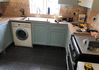 Light blue kitchen cabinets being fitted