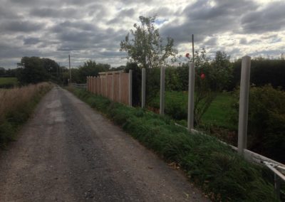 Concrete fence posts and wooden panels