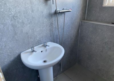 New white sink with grey tiling