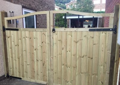 Double wooden gate on driveway