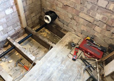 Fitting new plumbing and waste pipe under flooring