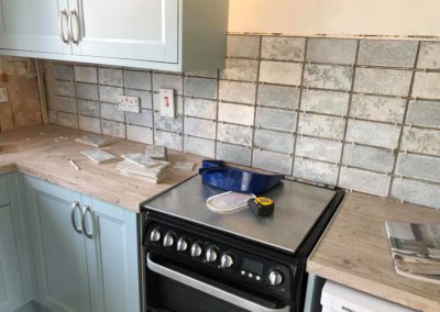 Tiling across new kitchen counter tops and cooker