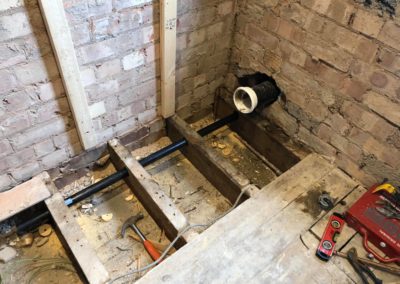 Fitting new plumbing and waste pipe under flooring