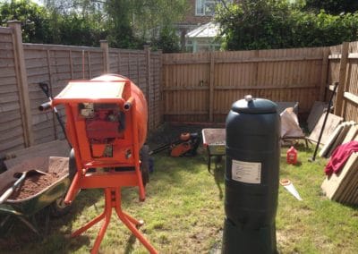 Cement mixer in garden with preparations for patio