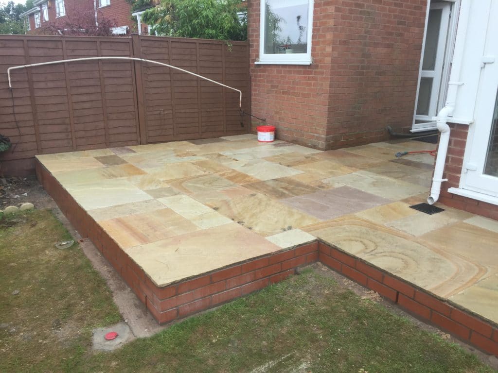 Finished tiled patio with brick border