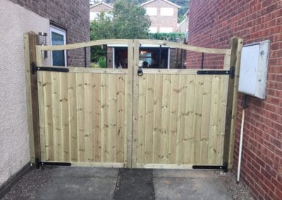 Double wooden gate on driveway