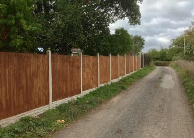Concrete fence posts and wooden panels