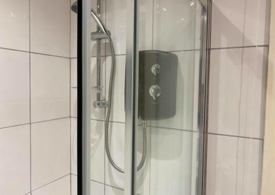 Black shower unit and glass enclosure
