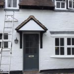 Painting windows of refurbished cottage