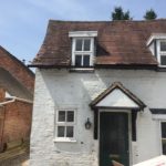 White cottage needing painting & repair
