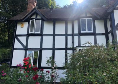 Exterior Painting of Black & White Timber House