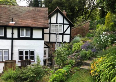 Exterior Painting of Black & White Timber House