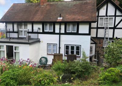 Exterior Painting of Black & White Timber House