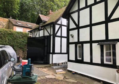 Exterior Painting of Black & White Timber House