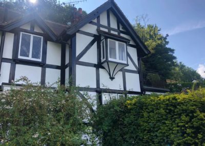 Exterior Painting of Black & White Timber House