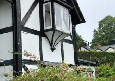 Exterior Painting of Black & White Timber House