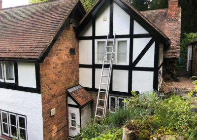 Exterior Painting of Black & White Timber House