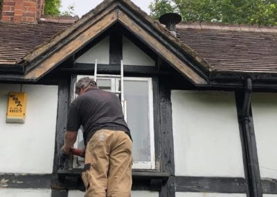 Exterior Painting of Black & White Timber House