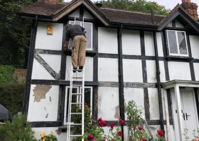 Exterior Painting of Black & White Timber House