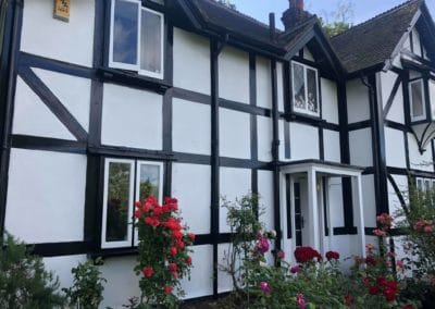 Exterior Painting of Black & White Timber House