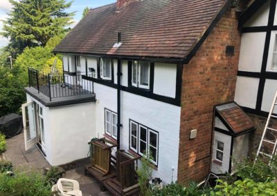 Exterior Painting of Black & White Timber House