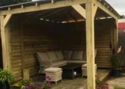 Wooden gazebo with sofa and coffee table