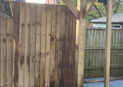 New fencing behind wooden gazebo